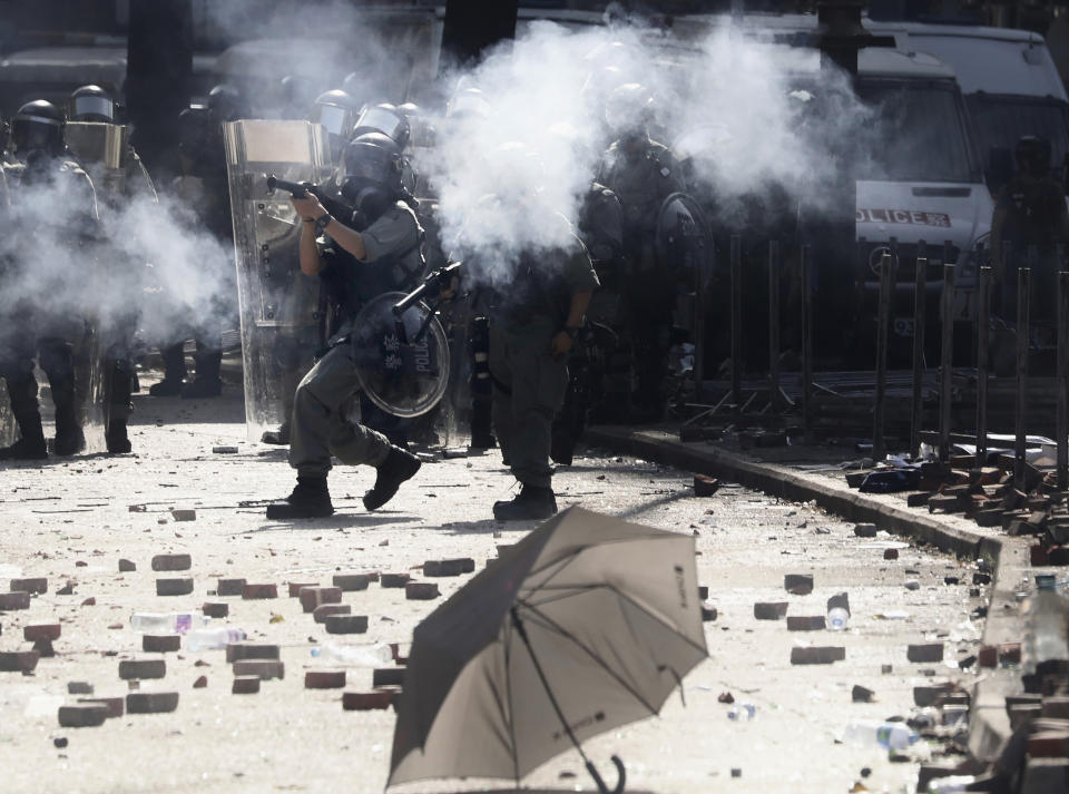 Police in riot gear fire tear gas during a confrontation with protestors at the Hong Kong Polytechnic University in Hong Kong, Sunday, Nov. 17, 2019. (AP Photo/Ng Han Guan)