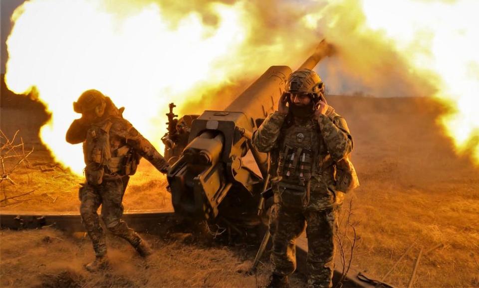 Ukrainian soldiers fire with a D-30 howitzer at Russian positions near Bakhmut, eastern Ukraine.