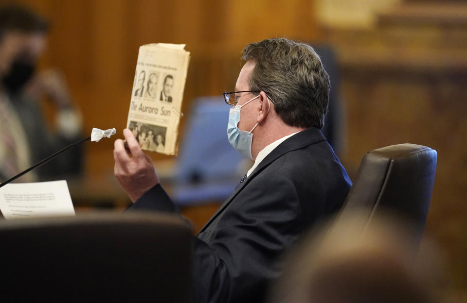 Randy Kady, 54, holds up a copy of a newspaper to illustrate to underline his testimony about the child sexual abuse accountability act during a hearing before the Senate Judiciary Committee in the State Capitol, Thursday, March 11, 2021, in Denver. Kady was sexually assaulted by a teacher in his youth. (AP Photo/David Zalubowski)