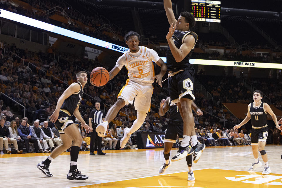 Tennessee guard Zakai Zeigler (5) passes the ball as he's defended by Wofford forward Belal El Shakery (24) during the first half of an NCAA college basketball game Tuesday, Nov. 14, 2023, in Knoxville, Tenn. (AP Photo/Wade Payne)