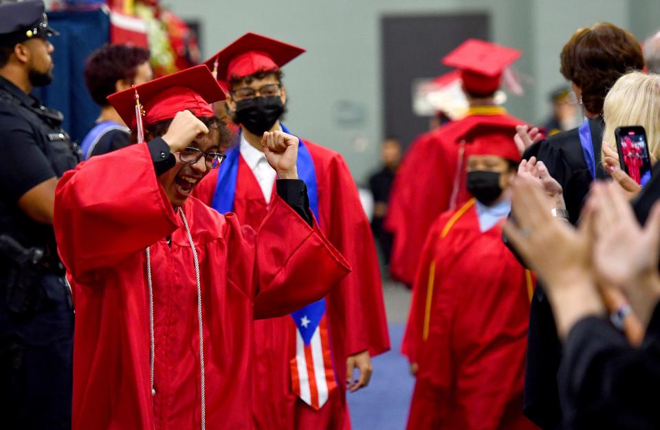 An excited graduate cheers as the South High Community School procession begins the ceremony at the DCU Center on Wednesday.