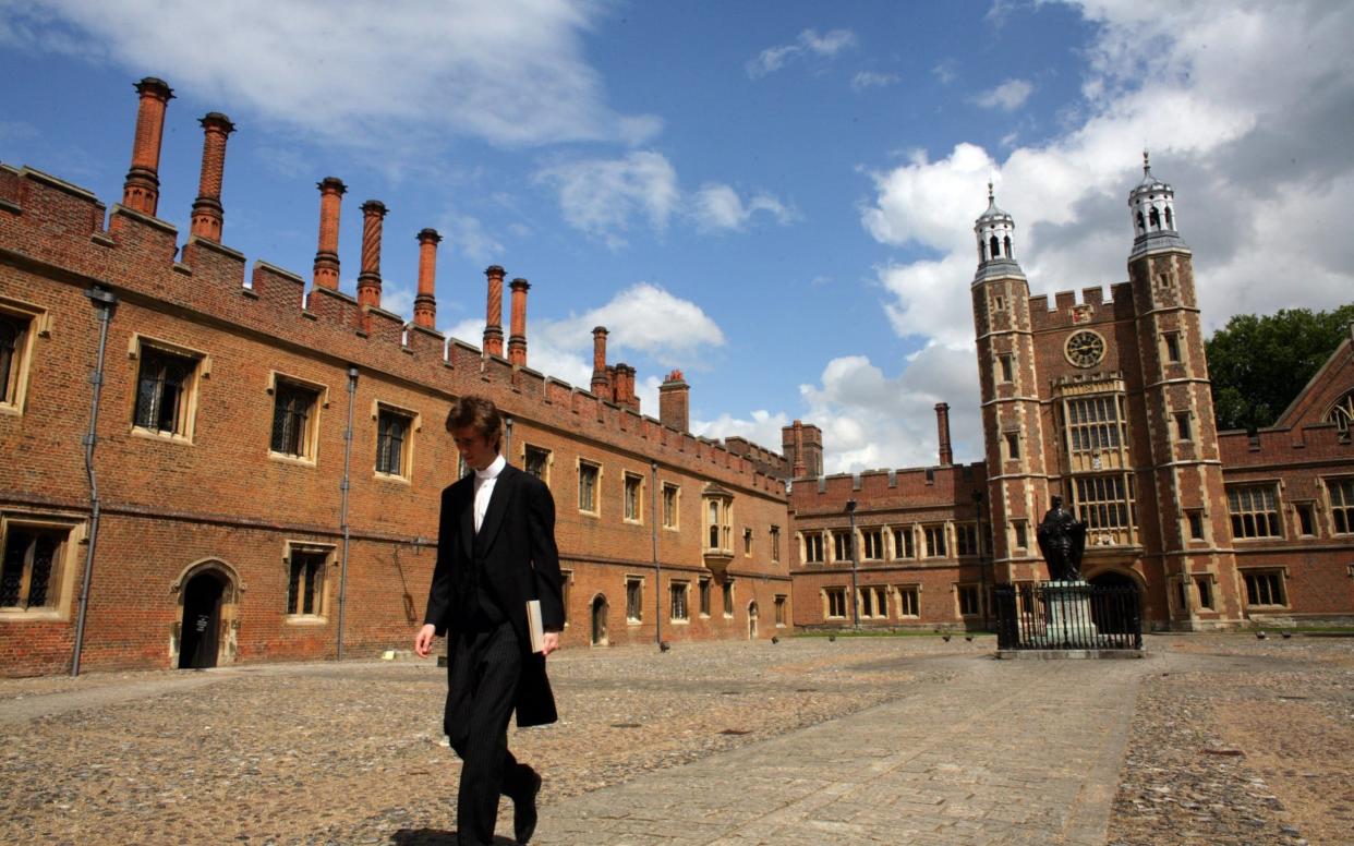 WINDSOR, UNITED KINGDOM - JUNE 2007: An Eton College pupil walks thorough School Yard with Luptons Tower in the background at Eton College, the iconic English private school, Eton College. Eton College was founded in 1440 by King Henry VI. The College originally had 70 King's Scholars or 'Collegers' who lived in the College and were educated free, and a small number of 'Oppidans' who lived in the town of Eton and paid for their education. Eton has a very long list of distinguished former pupils, including eighteen former British Prime Ministers.  - Christopher Furlong/Getty Images