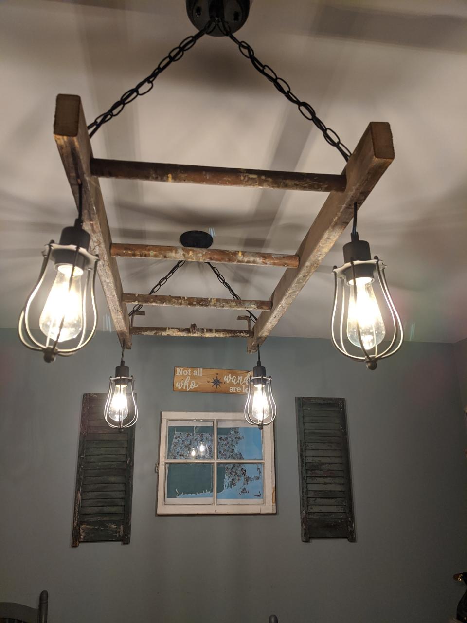 An old wooden ladder reimagined as a lighting fixture by Berkley residents Kim and Dan Arena, owners of Bostonian Repurposed.
