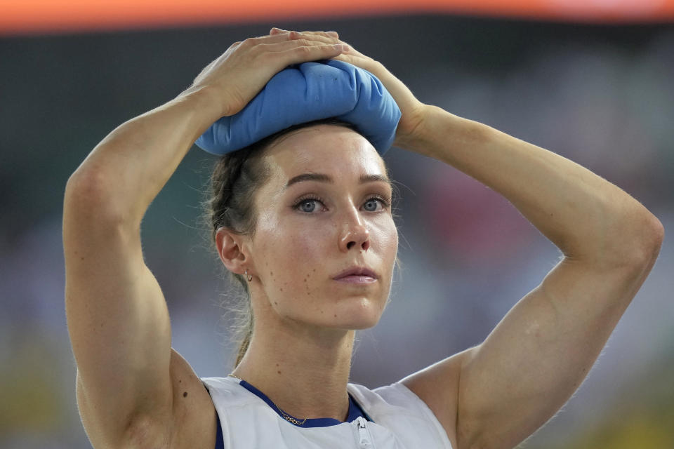 FILE - Lene Onsrud Retzius, of Norway, uses an ice pack on her head to lower her body temperature, between attempts in the Women's pole vault qualification during the World Athletics Championships in Budapest, Hungary, Monday, Aug. 21, 2023. (AP Photo/Matthias Schrader, File)