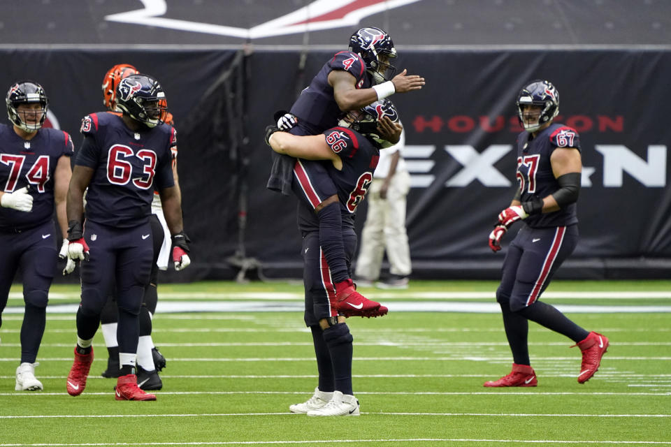 Houston Texans quarterback Deshaun Watson (4) celebrates with center Nick Martin (66) after throwing a touchdown pass against the Cincinnati Bengals during the first half of an NFL football game Sunday, Dec. 27, 2020, in Houston. (AP Photo/Eric Christian Smith)