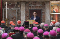 A survivor of sex abuse, who wished to remain anonymous, background right, delivers his testimony during a penitential liturgy attended by Pope Francis at the Vatican, Saturday, Feb. 23, 2019. The pontiff is hosting a four-day summit on preventing clergy sexual abuse, a high-stakes meeting designed to impress on Catholic bishops around the world that the problem is global and that there are consequences if they cover it up. (Vincenzo Pinto/Pool Photo Via AP)