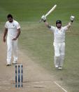 New Zealand's Brendon McCullum (R) acknowledges his 300 next to India's Zaheer Khan during the second innings of play on day five of the second international test cricket match at the Basin Reserve in Wellington, February 18, 2014.