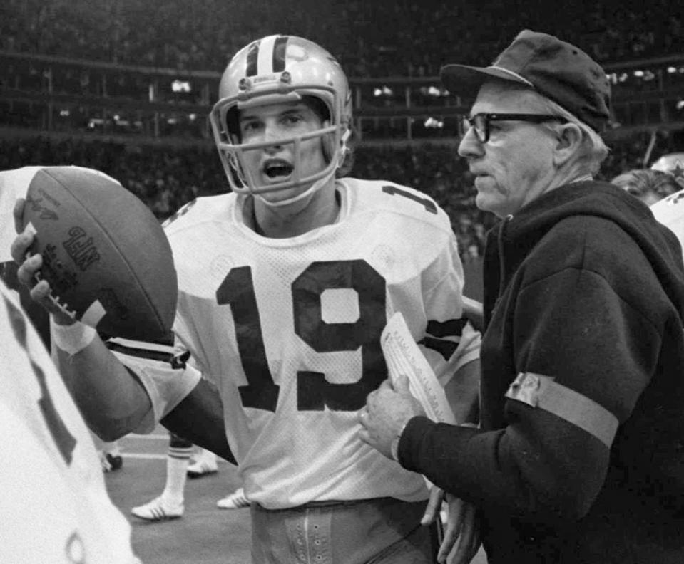 FILE - In this Nov. 28, 1974, Dallas Cowboys rookie quarterback Clint Longley walks off the field carrying the game ball after after he threw a long bomb to wide receiver Drew Pearson for a touchdown in the final seconds of their 24-23 win over the Washington Redskins in an NFL football game at Texas Stadium in Irving, Texas. Longley is dubbed “The Mad Bomber” after replacing an injured Roger Staubach and hitting Drew Pearson with a 50-yard, winning TD pass with 35 seconds left. (AP Photo/File)