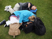 <p>Fans sleep while queuing for entry into the grounds on day one of the Wimbledon Lawn Tennis Championships at the All England Lawn Tennis and Croquet Club on June 24, 2013 in London, England.</p>