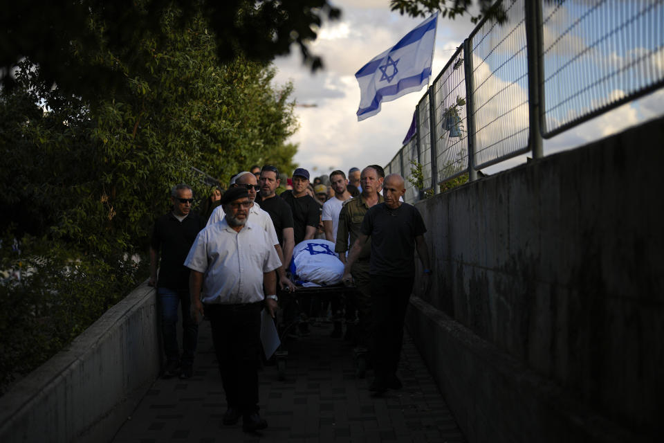 Mourners carry the body of Aviya Genut during a funeral in Kfar Saba, near Tel Aviv, Israel, Sunday, Oct. 15, 2023. (AP Photo/Francisco Seco)
