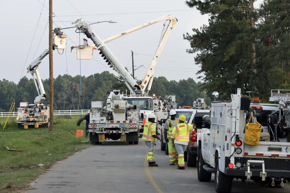 Utility crews work to repair damage caused by a tornado on Wednesday, July 19, 2023, on Town Hall Road in Dortches, N.C. (AP Photo/Chris Seward)
