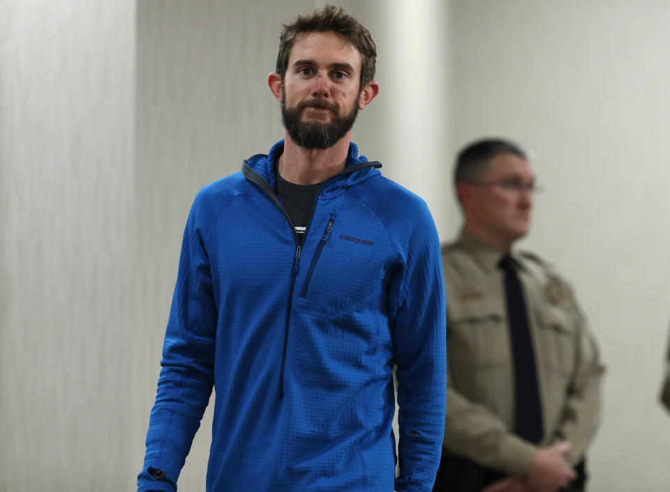 Travis Kauffman heads into a news conference Thursday, Feb. 14, 2019, in Fort Collins, Colo., about his encounter with a mountain lion while running a trail just west of Fort Collins last week. (AP Photo/David Zalubowski)