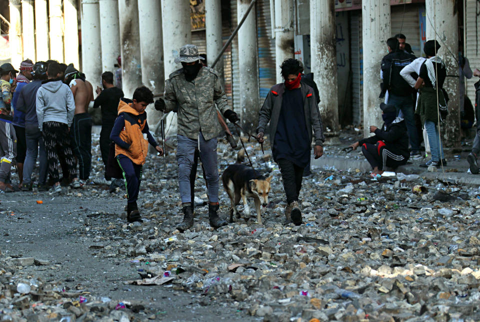 Anti-government protesters gather during clashes with security forces in Baghdad, Iraq, Saturday, Nov. 30, 2019. (AP Photo/Hadi Mizban)