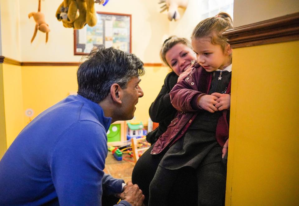 File photo: PM speaks to a young girl while visiting a dental surgery on Thursday (PA)