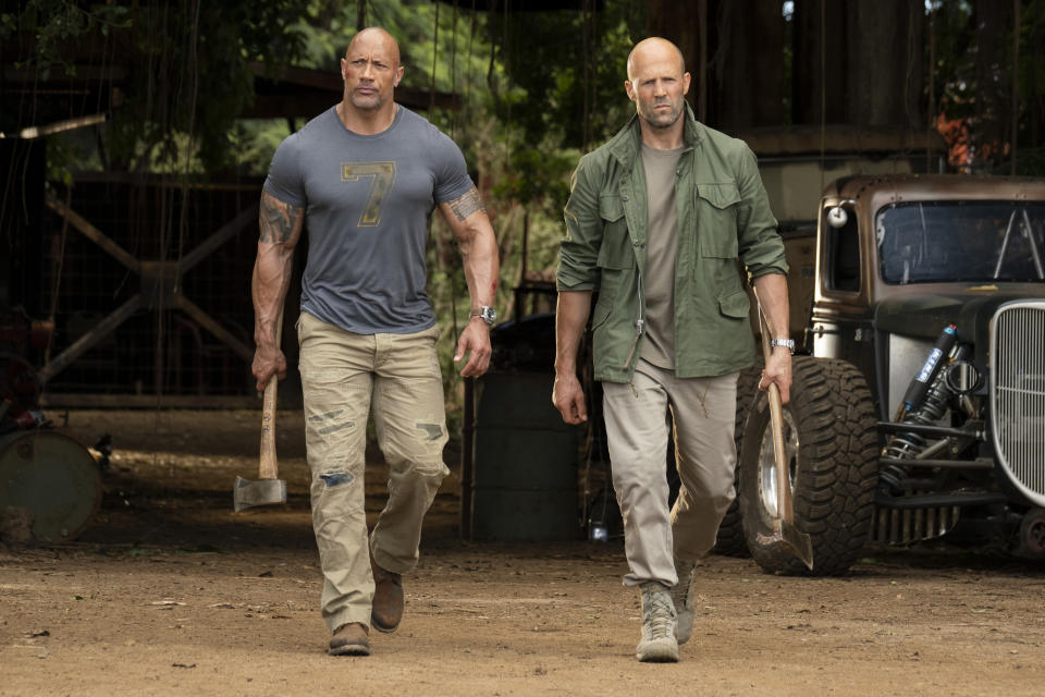 This image released by Universal Pictures shows Dwayne Johnson, left, and Jason Statham in a scene from "Fast & Furious Presents: Hobbs & Shaw." (Frank Masi/Universal Pictures via AP)