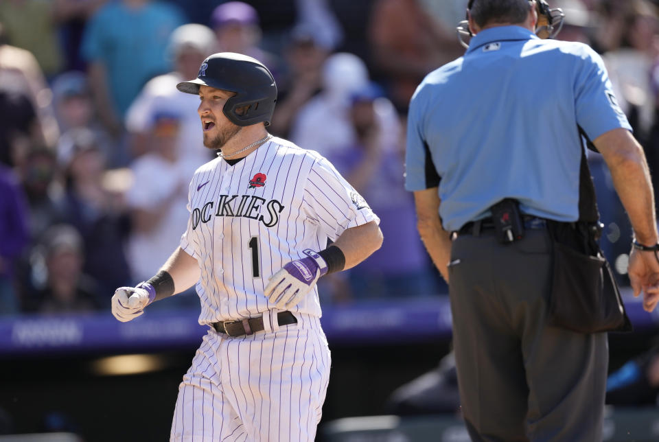 Colorado Rockies' Garrett Hampson scores on a double by pinch-hitter Yonathan Daza off Miami Marlins relief pitcher Cole Sulser in the seventh inning of a baseball game Monday, May 30, 2022, in Denver. (AP Photo/David Zalubowski)