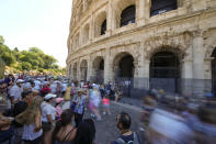 A guide illustrates the history of the Colosseum to a group of tourists, in Rome, Monday, June 20, 2022. In Italy, tourists — especially from the U.S. — returned this year in droves. The run-up to Easter was especially notable in Rome, reflecting pent-up demand to visit perennial all-star sites like the Sistine Chapel and the Colosseum. (AP Photo/Andrew Medichini)