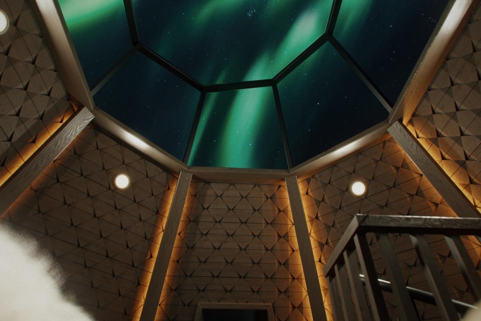 View of glass dome roof in cabin during northern light