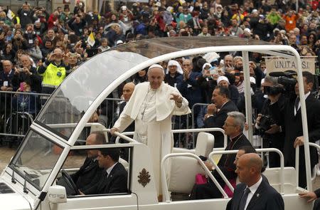 Pope Francis waves to the faithful from popemobile as he arrives to celebrate a Holy Mass in Carpi, Italy, April 2, 2017. REUTERS/Alessandro Garofalo