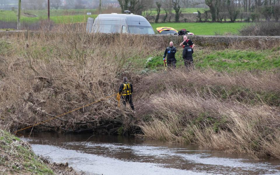 Police divers enter the water of the River Wyre - Jason Roberts/PA Wire