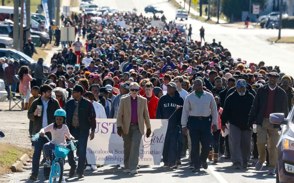 A large crowd of marchers moves along Martin Luther King Jr. Blvd. during the Unity March honoring Martin Luther King Jr. Monday, Jan. 15, 2018 in Tuscaloosa. [Staff Photo/Gary Cosby Jr.]