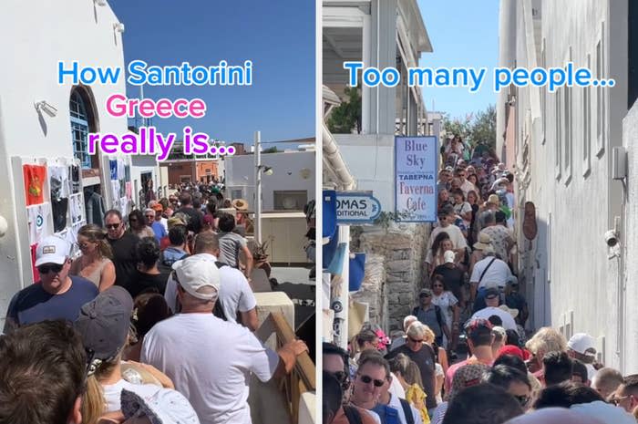 A street crowded with tourists in Santorini, Greece, with signs for Blue Sky, Taverna and Cafe, illustrating overtourism. The text reads: "What Santorini in Greece is really like... Too many people..."