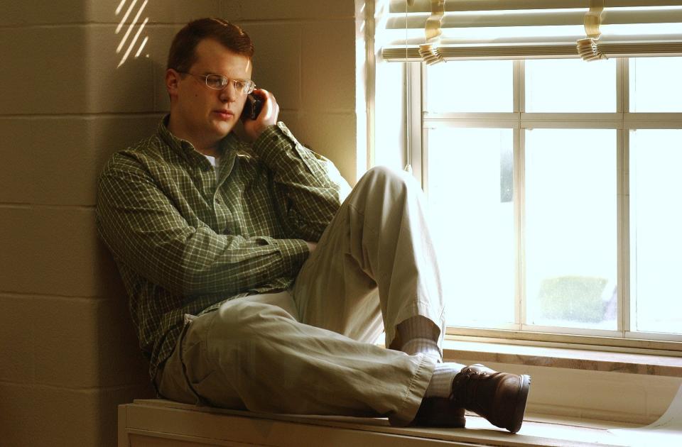 Hollan Holm has trouble every year on the anniversary of his near-death experience. On Dec. 1, 1997, he was shot in the head by a classmate at Heath High School. Here, Holm is photographed talking on the phone on the fifth anniversary of the shooting, in 2002. Holm tells his story in Episode 8 of the USA Today podcast Aftermath. (File photo/Pam Spaulding)

-Text: November 25, 2002 photo by Pam SpauldingThis is the fifth year anniversary of the Heath High School Shooting. One of the shooting victims was Hollan Holm who is now a student at Western Ky. University. here talking on the phone to a reporter At first he thought he wanted to be a journalist based on his bad experience with the press after the shooting. Now he has decided to major in history.
Caption: Hollon Holm
 Holm, who was wounded, said, ``it's what I saw after I was shot that bothers me most . . . seeing the people on the floor.''