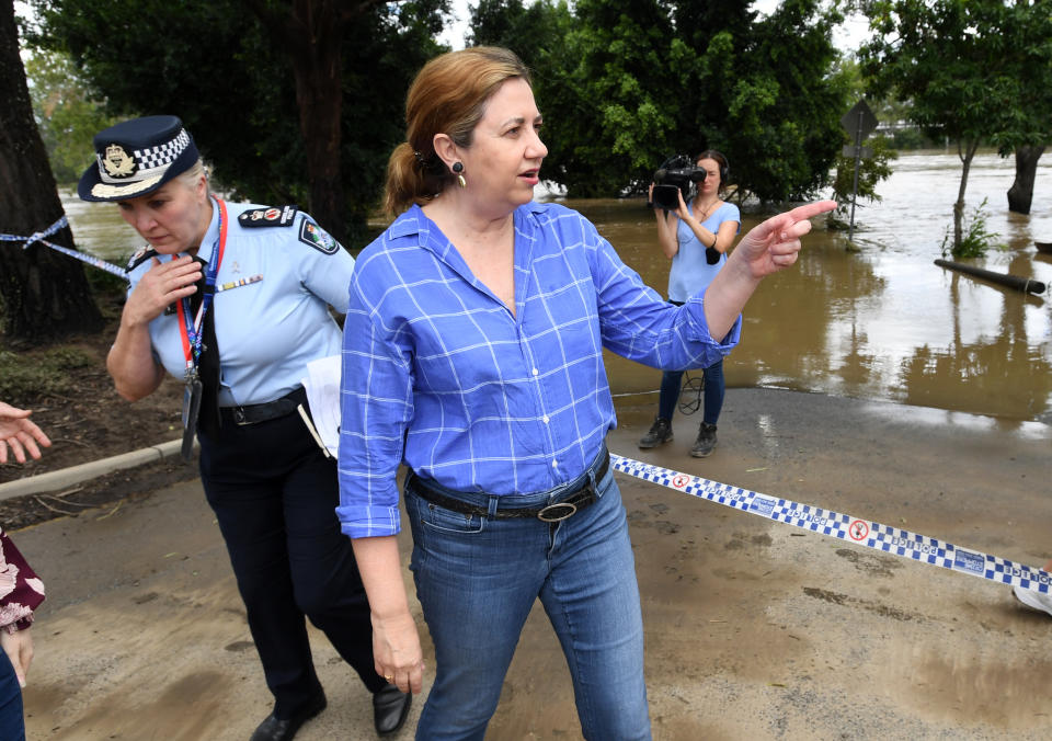 Queensland Premier Annastacia Palaszczuk (right) is seen inspecting flood damage in the suburb of Jindalee in Brisbane, Tuesday, March 1, 2022. 