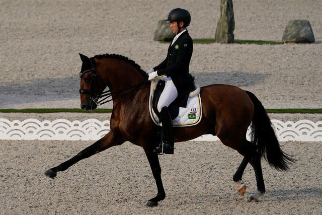 Brazil’s Joao Victor Marcari Oliva, riding Escorial Horsecampline, competes during the dressage Grand Prix in Tokyo