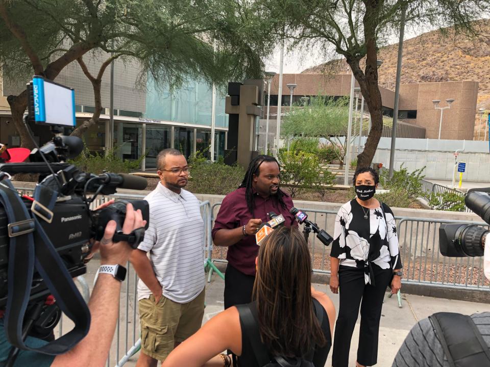 Kenneth Smith with Unity Collective, Janelle Wood with Black Mother's Forum, and Jacob Raiford with the W.E. Rising Project call for the firing of a Tempe police officer accused of holding an unarmed black man at gunpoint during a media briefing on Sept. 8, 2020.