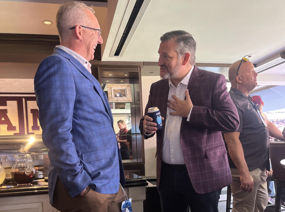 SEC commissioner Greg Sankey talks to Sen. Ted Cruz during the Alabama-Texas A&M game. (Photo credit: Yahoo Sports)