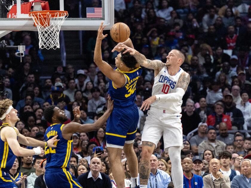 Clippers center Daniel Theis, right, tries to block a shot by Golden State Warriors forward Trayce Jackson-Davis.
