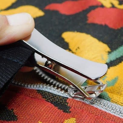 An assistive zipper puller