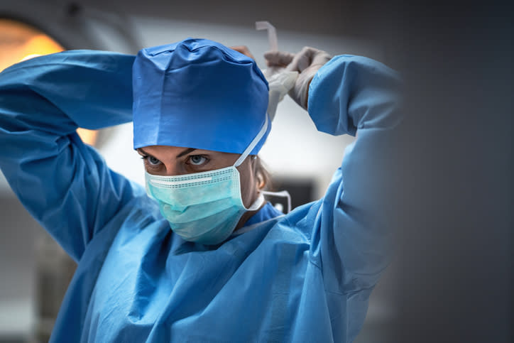 a doctor fastening their face mask