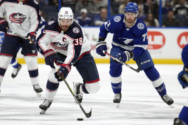 Columbus Blue Jackets center Boone Jenner (38) breaks out ahead of Tampa Bay Lightning center Anthony Cirelli (71) during the first period of an NHL hockey game Thursday, Dec. 15, 2022, in Tampa, Fla. (AP Photo/Chris O'Meara)