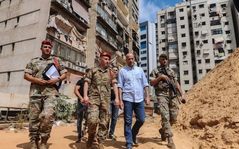 Lebanese military intelligence officers inspect the site of the alleged Israeli drone attack in Beirut - Credit: REX/NABIL MOUNZER