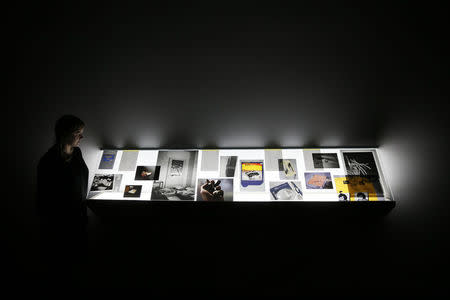 A woman looks at Source material from the artist's archive by Tris Vonna-Michell, at Tate Britain in London September 29, 2014. REUTERS/Stefan Wermuth