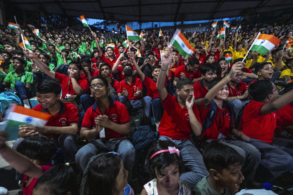 Schoolchildren celebrate the successful landing of spacecraft Chandrayaan-3 on the moon, in a school in Guwahati, India, Wednesday, Aug. 23, 2023. India has landed a spacecraft near the moon's south pole, an unchartered territory that scientists believe could hold vital reserves of frozen water and precious elements, as the country cements its growing prowess in space and technology. (AP Photo/Anupam Nath)