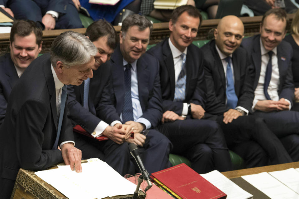 Chancellor of the Exchequer Philip Hammond delivers his Spring Statement to lawmakers in the House of Commons, London, Wednesday March 13, 2019. Political crisis in Britain is sparking anxiety across the European Union, as fears rise that Britain will crash out of the bloc on March 29 without a withdrawal agreement to smooth the way. (Mark Duffy/UK Parliament via AP)