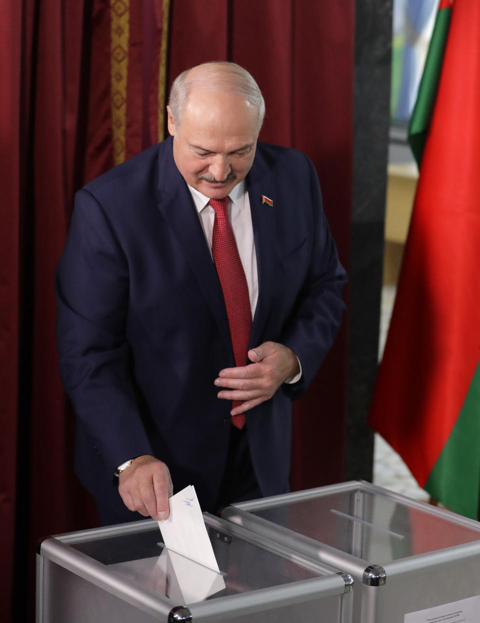 Belarusian President Alexander Lukashenko casts his ballot at a polling station during parliamentary elections, in Minsk, Belarus, Sunday, Nov. 17, 2019. (AP Photo/Sergei Grits)