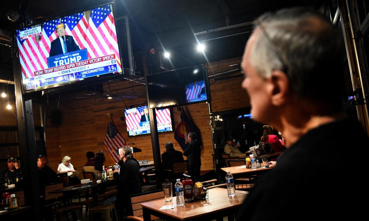 <span>A broadcast of Trump’s Super Tuesday speech plays at Wide Open Saloon in Sedalia, Colorado on 5 March 2024. </span><span>Photograph: Jason Connolly/AFP/Getty Images</span>