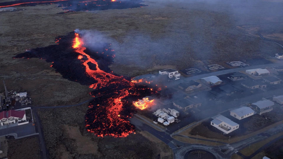 Lava flows from a volcano as houses burn in Grindavik, Iceland, January 14, 2024, in this screen grab obtained from a social media video.   / Credit: Bjorn Steinbekk/@bsteinbekk via Instagram/via REUTERS