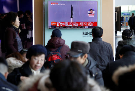 Passengers watch a TV screen broadcasting a news report on North Korea firing a ballistic missile into the sea off its east coast, at a railway station in Seoul, South Korea, February 12, 2017. REUTERS/Kim Hong-Ji