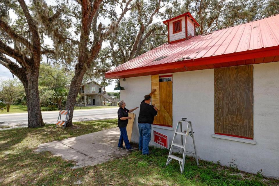 Pastor Robert and Gail Carter board up the Steinhatchee Lighthouse of Prayer church in Steinhatchee, Florida in preparation for Hurricane Idalia on Tuesday, August 29, 2023.