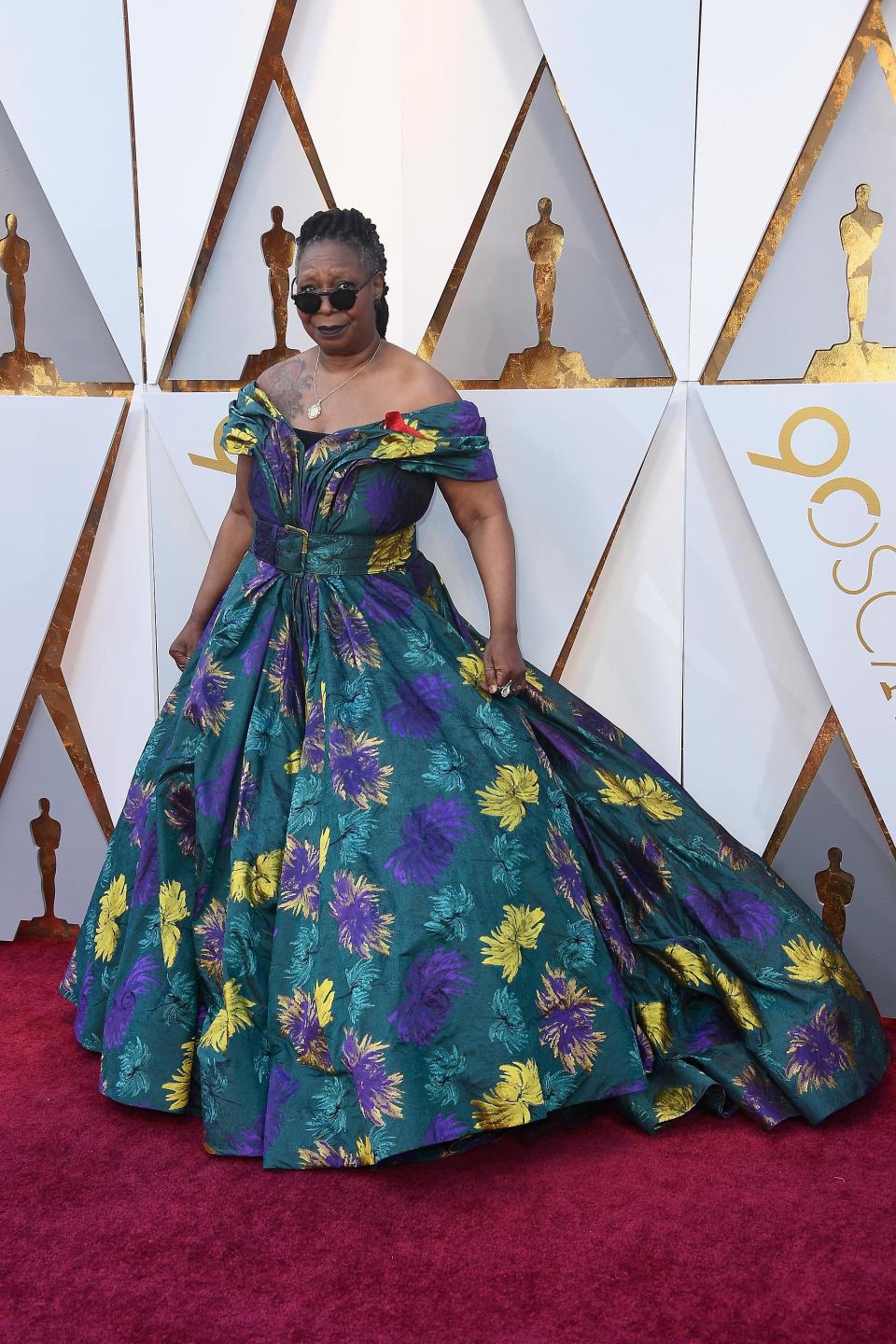 <p>Whoopi Goldberg wears a very feather-print off-the-shoulder gown paired with sunglasses.</p>