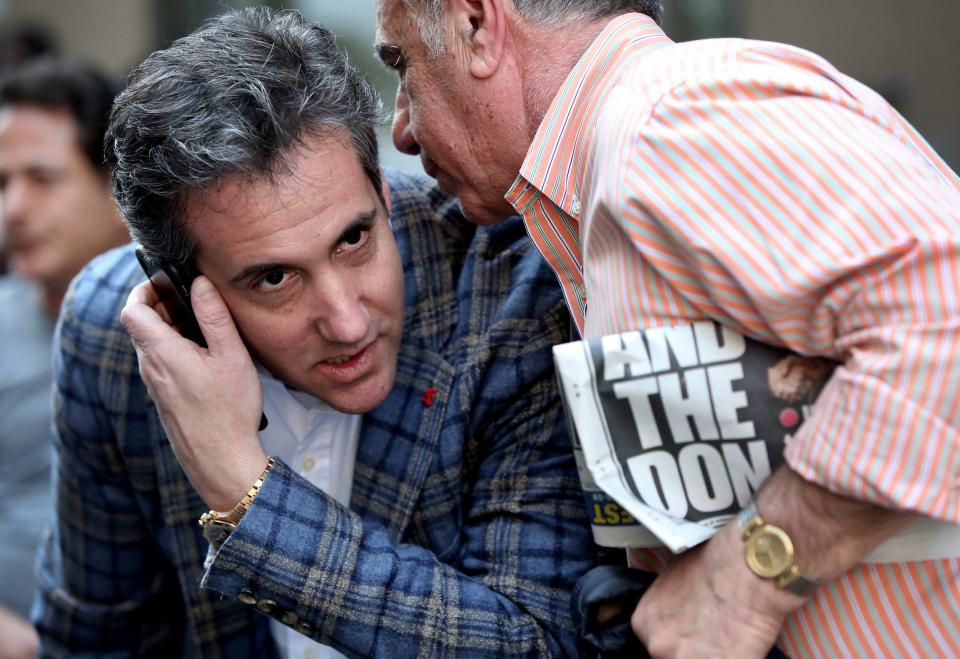 Michael Cohen listens to a call following the FBI's reported raids on his home, office, and hotel room