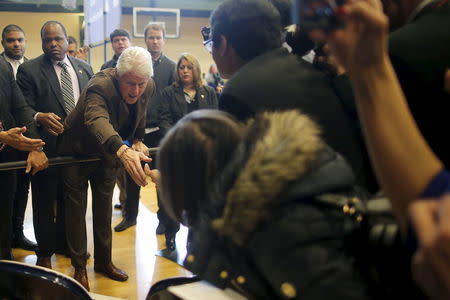 Former U.S. President Bill Clinton greets audience members while campaigning for his wife, U.S. Democratic presidential candidate Hillary Clinton, in Nashua, New Hampshire, January 4, 2016. REUTERS/Brian Snyder