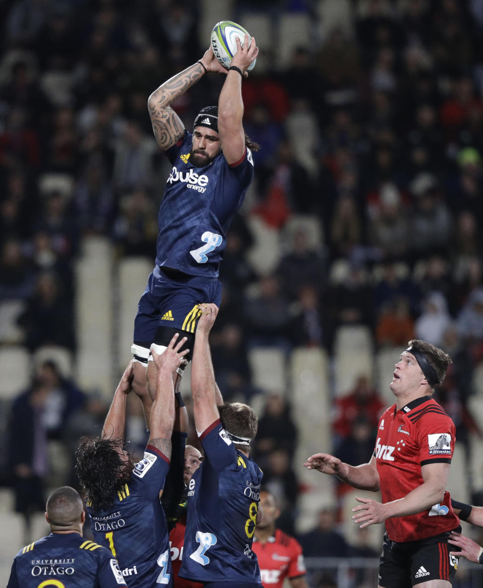 Highlanders Jackson Hemopo is held aloft by teammates as he wins a lineout during the Super Rugby quarterfinal between the Crusaders and the Highlanders in Christchurch, New Zealand, Friday, June 21, 2019. (AP Photo/Mark Baker)