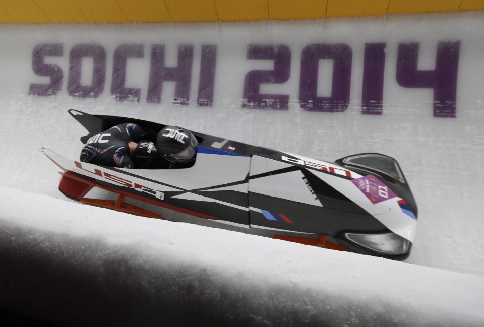 The team from the United States USA-1, piloted by Steven Holcomb and brakeman Steven Langton, take a curve during the men's two-man bobsled competition at the 2014 Winter Olympics, Sunday, Feb. 16, 2014, in Krasnaya Polyana, Russia. (AP Photo/Natacha Pisarenko)