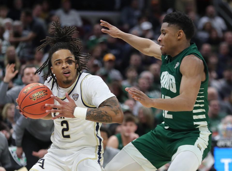 Akron's Greg Tribble (2) drives against Ohio's Jaylin Hunter (12) during the first half in the semifinals of the Mid-American Conference Tournament on Friday in Cleveland.